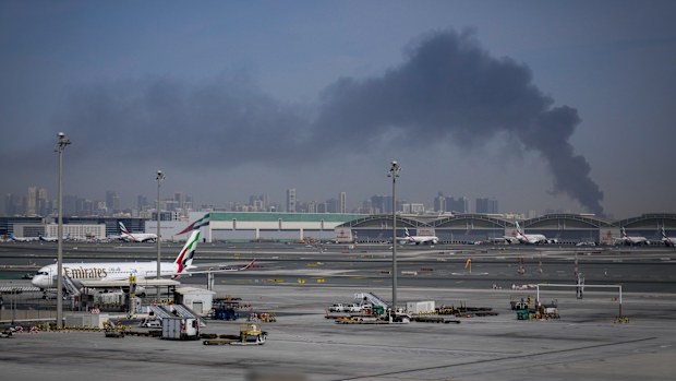 A plume of smoke caused by an Iranian strike near the Dubai International Airport after its closure on Sunday. 