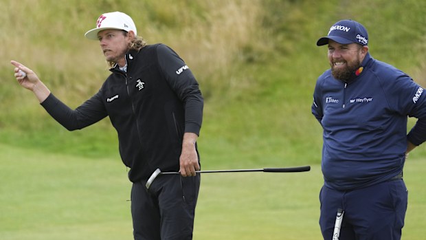 Cameron Smith of Australia gestures as he stands with Shane Lowry, right, of Ireland during his opening round of the British Open Golf Championships at Royal Troon golf club in Troon, Scotland, Thursday, July 18, 2024. (AP Photo/Jon Super)