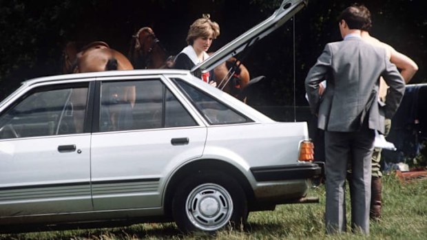 Princess Diana standing next to car given to her by Prince Charles