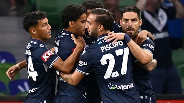 Victory players celebrate a goal by Nishan Velupillay.