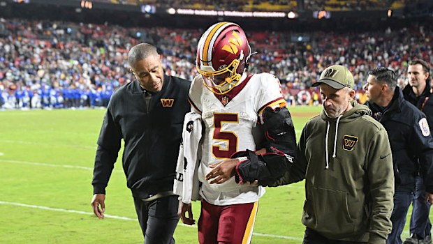 Jayden Daniels #5 of the Washington Commanders walks to locker room.