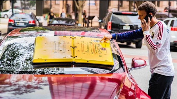 New device sticks onto car windshield until driver pays parking fine. 