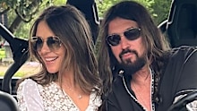 The couple then posed in a car with one of Cyrus' dogs. 