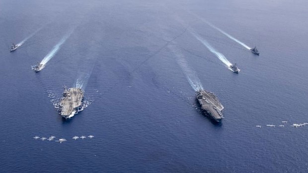 US Navy aircraft from Carrier Air Wing 5 and Carrier Air Wing 17 fly in formation over the Nimitz Carrier Strike Force (CSF). 