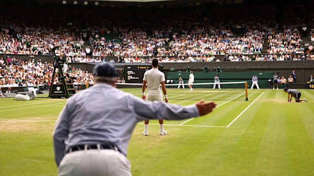 A line judge calls out during the Men's Singles Quarter Final match between Novak Djokovic of Serbia and Andrey Rublev during day nine of The Championships Wimbledon 2023 at All England Lawn Tennis and Croquet Club on July 11, 2023 in London, England. (Photo by Julian Finney/Getty Images)