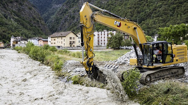 An excavator removes stones from the bed of the Navizence river, which flows into the Rhone, in Chippis, canton Valais, Switzerland.