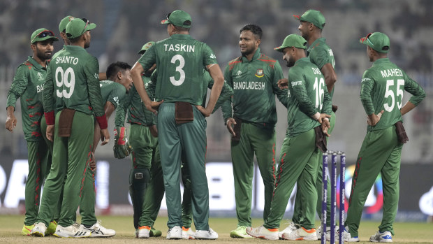 Bangladesh's captain Shakib Al Hasan, fourth right, and teammates await third umpire's decision for the wicket of Netherlands' Sybrand Engelbrecht during the ICC Men's Cricket World Cup match between Bangladesh and Netherlands in Kolkata, India, Saturday, Oct. 28, 2023. (AP Photo/Bikas Das)