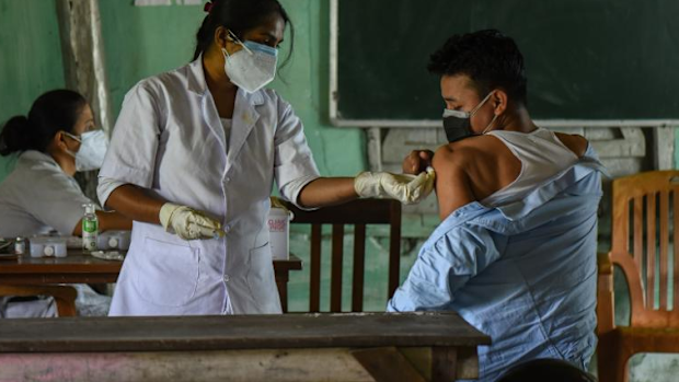 A young man receives a COVID-19 vaccine in Guwahati, India. 