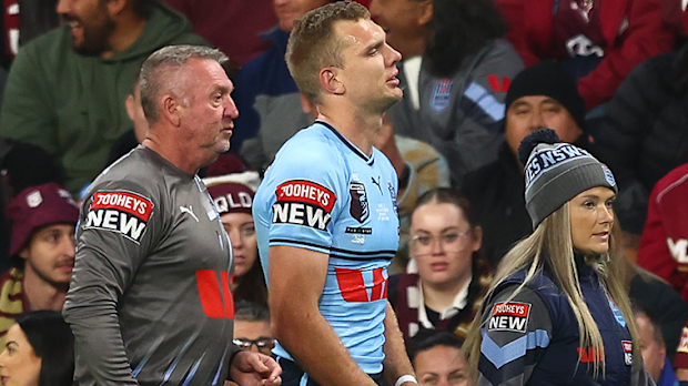 Tom Trbojevic is assisted off the field after suffering a peck injury in the opening minutes of Origin II.