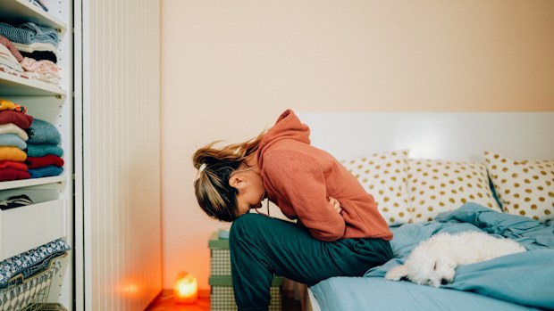 Woman hunched over in pain