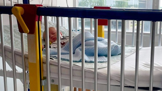 In this June 2021 photo, a six-week-old baby boy, Beau, lies in a hospital bed in Matoon, Illinois. Beau developed a bad cough after his dedication ceremony at church. His mother, who has a medical background, suspected respiratory syncytial virus when she opened his sleeper and saw his chest heaving with laboured breathing. (LaRanda St. John via AP)