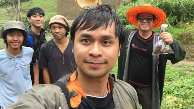 Narin Chomphuphuang, center, takes a photo of the survey team. YouTuber JoCho Sippawat is on the far left.