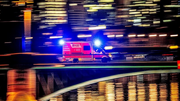 An ambulance speeds over a bridge in Frankfurt, Germany, 