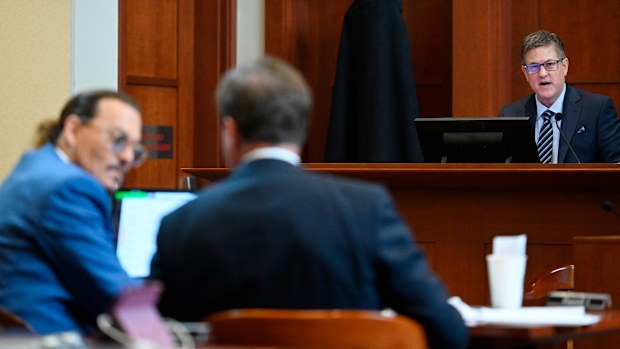Douglas Bania (R), licensing and damages expert, testifies in the courtroom at the Fairfax County Circuit Court in Fairfax, Virginia, on May 24, 2022.