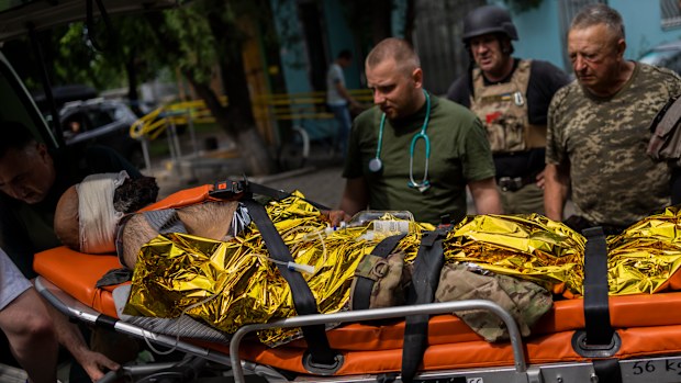 An injured Ukrainian serviceman is evacuated to a hospital in the Donetsk oblast region, eastern Ukraine, Sunday, June 5, 2022. (AP Photo/Bernat Armangue)