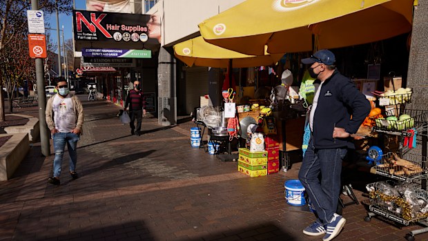 Shopkeeper Elias waits for customers in Fairfield, Sydney.