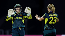 Alyssa Healy celebrates with teammate Sophie Molineux after taking the wicket of Sophie Devine of New Zealand.