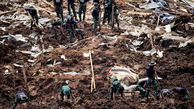Rescuers search for victims of an earthquake-triggered landslide in Cianjur, West Java, Indonesia, Wednesday, Nov. 23, 2022. 