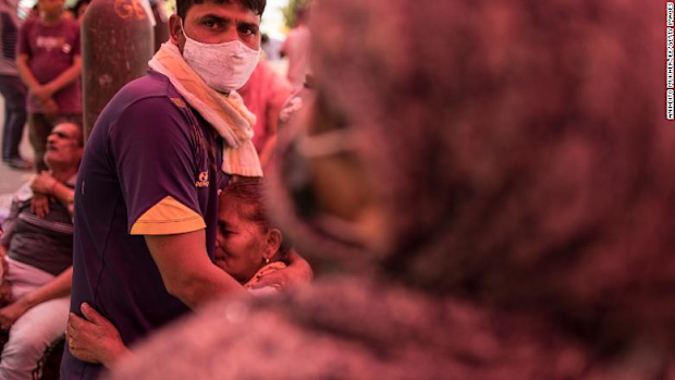 A woman hugs her son after arriving to receive free oxygen in New Delhi on May 1.