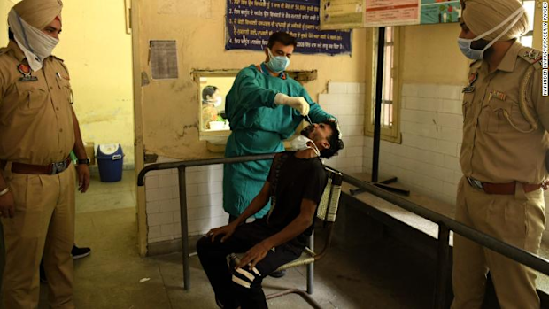 A health worker administers a COVID-19 test on the outskirts of Amritsar on May 3.