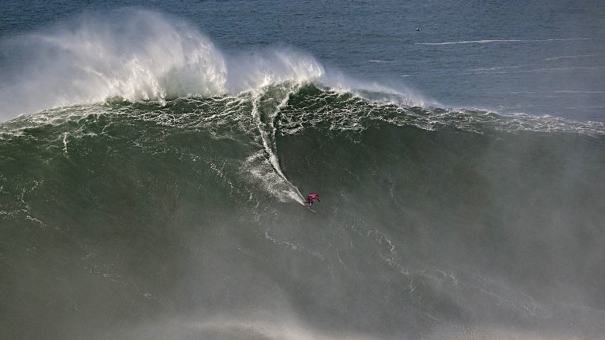 'Crazy day': Surfers take on 60ft waves in Portugal