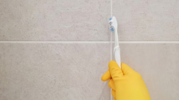 Cleaning bathroom titles and grout.