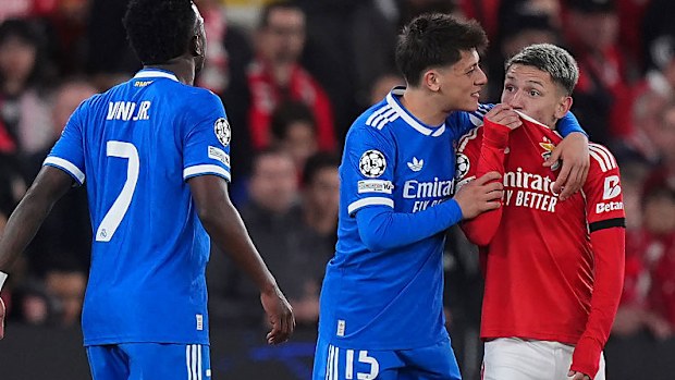 Gianluca Prestianni of Benfica speaks towards Vinicius Junior of Real Madrid.