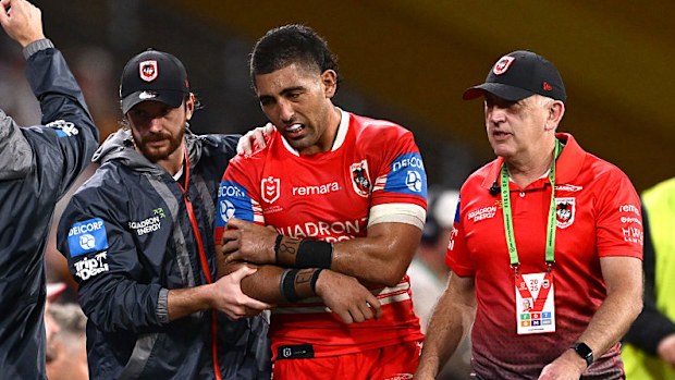 Emre Guler of the Dragons is assisted by trainers off the field.