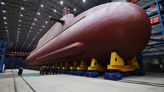 In this undated photo provided Thursday, Dec. 25, 2025, by the North Korean government, its leader Kim Jong Un inspects a nuclear-powered submarine under construction at an undisclosed location in North Korea.