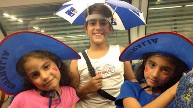 Rahma and her sisters, Mesk and Hareer, pictured on their first Australia Day in the country.