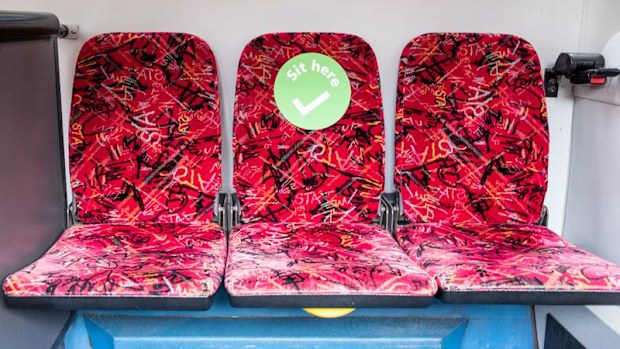 A green sticker shows where people can sit on buses across the NSW train and bus network.