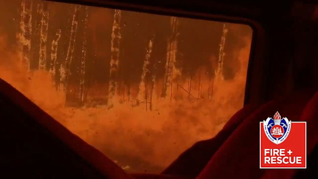 A Fire & Rescue NSW crew has been forced to shield themselves inside their truck as they passed through an Emergency fire front zone.