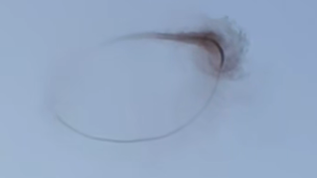 A black ring in the sky has slowly disappeared before shocked witnesses, raising questions about its origin. 