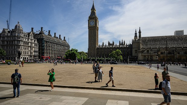 Tourists walk on the sun-baked Parliament Square on July 14, 2022 in London, England. 