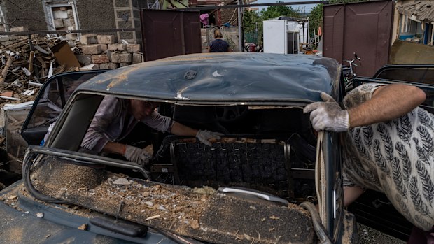 Residents inspect damages after a missile strike in Druzhkivka, eastern Ukraine, Sunday, June 5, 2022. (AP Photo/Bernat Armangue)