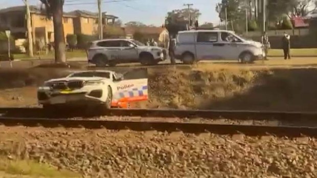Police narrowly avoid being hit by train chasing motorcyclist in Sydney's west