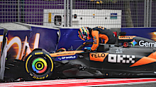 Oscar Piastri climbs out of his damaged McLaren after crashing during the Azerbaijan Grand Prix.