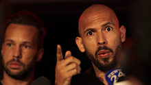 Andrew Tate, right, speaks to media next to his brother Tristan, after returning from the United States, outside his home on the outskirts of Bucharest, Romania, Saturday, March 22, 2025. (AP Photo/Vadim Ghirda)