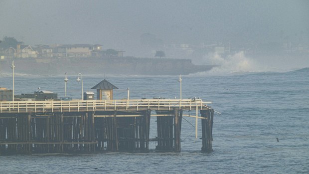 Damage is seen on the end of Santa Cruz Wharf during high surf in Santa Cruz, Calif., Monday, Dec. 23, 2024. (AP Photo/Nic Coury)