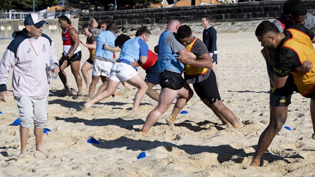 Wallabies players train on Coogee Beach.
