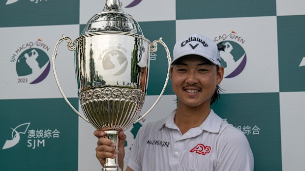 Australia's Min Woo Lee poses with the winner's trophy after triumphing at the Macau Open.