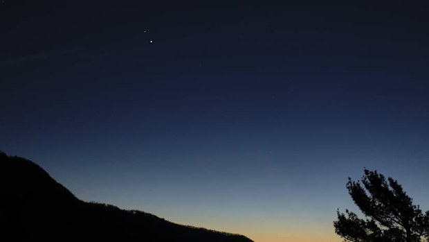 Saturn, top, and Jupiter, below, are seen after sunset from Shenandoah National Park, in Virginia. 