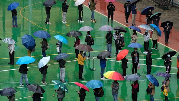 Residents line up to get tested for the coronavirus at a temporary testing centre despite the rain in Hong Kong.