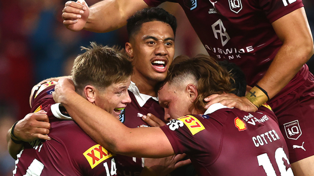 Murray Taulagi of the Maroons celebrates with teammates after scoring a try.