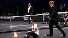A protester lights a fire on the court on day one of the Laver Cup at the O2 Arena, London. Picture date: Friday September 23, 2022. (Photo by John Walton/PA Images via Getty Images)