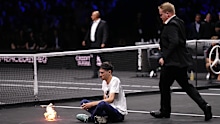 A protester lights a fire on the court on day one of the Laver Cup at the O2 Arena, London. Picture date: Friday September 23, 2022. (Photo by John Walton/PA Images via Getty Images)