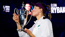 Elena Rybakina of Kazakhstan poses with the champions trophy.