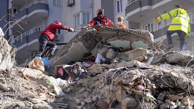 Emergency teams search for people in the rubble in a destroyed building in Adana, southern Turkey.
