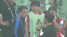 DPR Korea's coach argues with the referee.