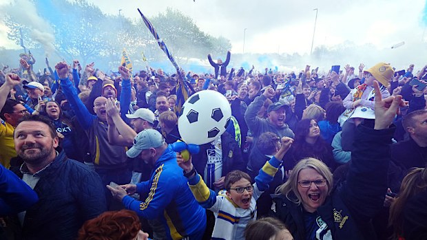 Leeds United fans celebrate promotion to the Premier League.